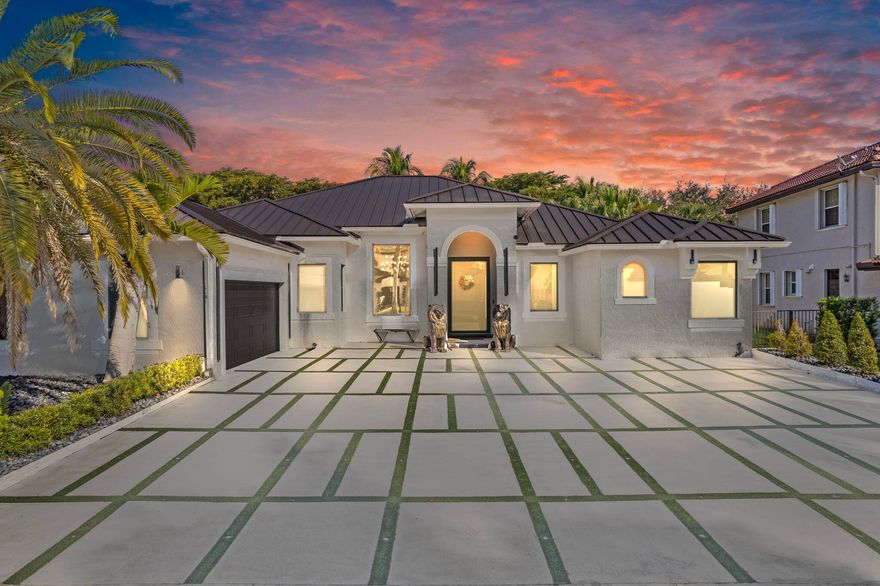 A Masterpiece of Modern Luxury! This exquisite home is a true standout, boasting premium upgrades and thoughtful details throughout. Step through the frosted entrance glass door and into a world of elegance. With impact windows and doors, glowing turf stone pavers in the front and rear, and LED accent lights, this home exudes curb appeal day and night. Outdoor Oasis: Entertain and relax in your personal paradise, featuring an outdoor shower, two gas-powered fire pits, a hot tub spa, and a projector screen for outdoor movie nights. The side-load garage and durable metal roof complete the exterior's sophisticated design.Gourmet Kitchen:The chef's dream kitchen boasts:Custom exotic marble counters and backsplash with LED lighting.Double islands featuring continuous waterfall