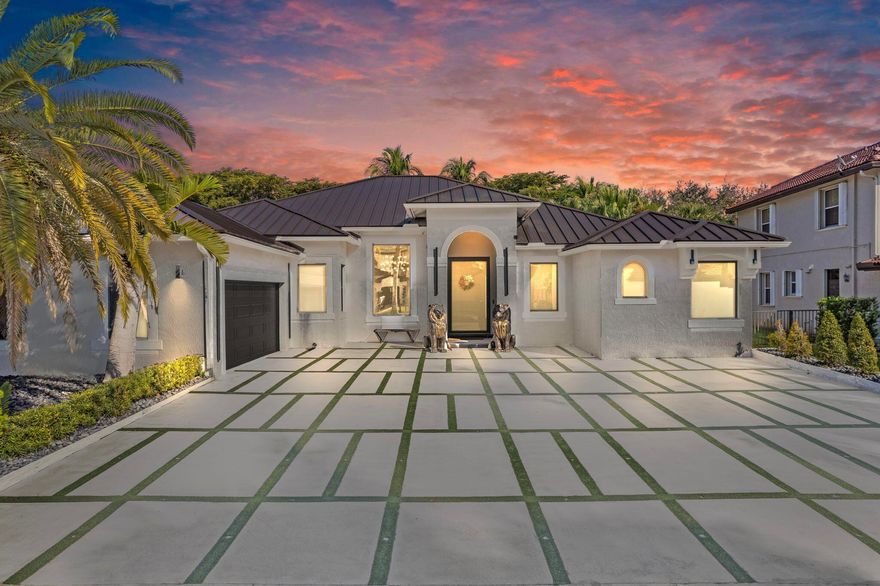 A Masterpiece of Modern Luxury! This exquisite home is a true standout, boasting premium upgrades and thoughtful details throughout. Step through the frosted entrance glass door and into a world of elegance. With impact windows and doors, glowing turf stone pavers in the front and rear, and LED accent lights, this home exudes curb appeal day and night. Outdoor Oasis: Entertain and relax in your personal paradise, featuring an outdoor shower, two gas-powered fire pits, a hot tub spa, and a projector screen for outdoor movie nights. The side-load garage and durable metal roof complete the exterior's sophisticated design.Gourmet Kitchen:The chef's dream kitchen boasts:Custom exotic marble counters and backsplash with LED lighting.Double islands featuring continuous waterfall