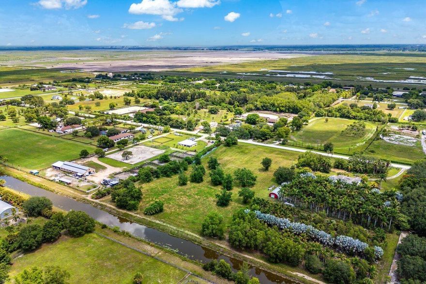 Cleared, Build-Ready & Full of Possibility - 5 Acres in Wellington's Rustic RanchesWelcome to a rare offering in one of Wellington's most coveted equestrian neighborhoods. This cleared, 5-acre lot is build-ready, zoned agricultural, and offers unrestricted freedom to create the custom estate, horse farm, or private homestead you've always dreamed of.Set alongside a peaceful canal that adds natural beauty and privacy, this high-and-dry property features City Water access at the road and no ponds, giving you full use of the land for whatever your lifestyle demands.The lot is fully cleared and ready to build. It's zoned agricultural, so you can bring your horses, build a barn, and keep livestock or chickens. With no ponds on site, you can maximize every inch of usable space.