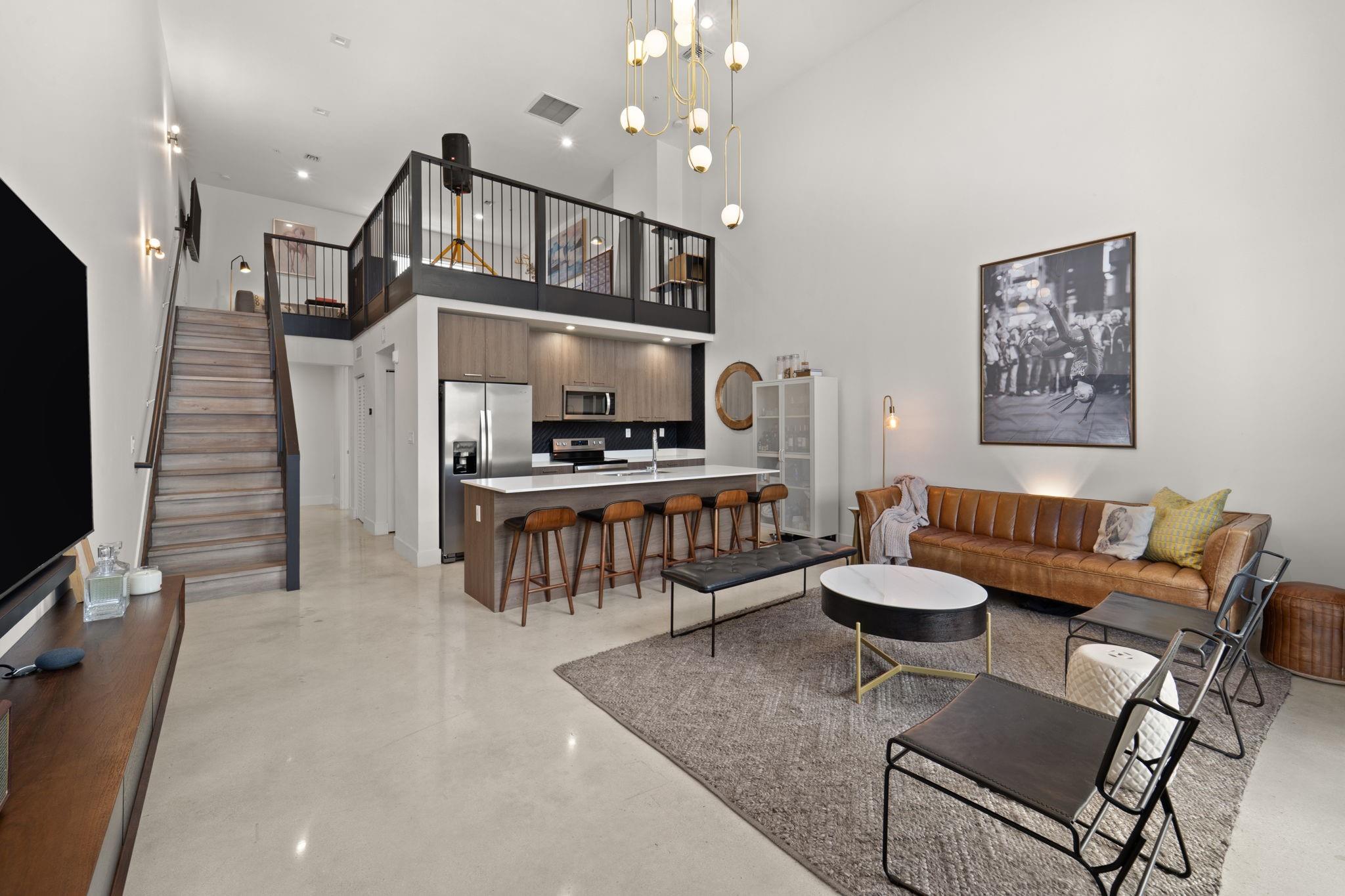 Fall in love with this NYC-style loft with an ultra-low $165/mo maintenance. Built in 2020, this spacious 2-bed, 1-bath condo delivers modern design. An elegant European kitchen showcases an oversized island, quartz counters, soft-close cabinetry, & stainless steel appliances. Soaring 18-ft ceilings & large impact windows drench the space in natural light. Polished concrete floors below & durable vinyl in the loft keep things sleek & low-maintenance. Flexible loft bedroom is ideal for guests, office, or studio. Location is unbeatable: URBN Village on Fifth Avenue adds resort-style appeal with its inviting pool area, the perfect place to unwind. Surrounded by parks and minutes to Wilton Manors, Federal Hwy, the Beach, and the Culinary Arts District. Don't miss this amazing condo!