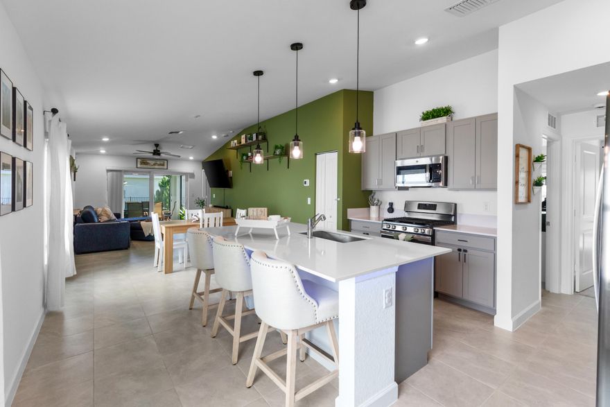 This new single-story home features a smart layout designed for ease-of-living and entertainment. An open-concept layout connects the well-equipped kitchen featuring Quartz countertops, stainless appliances, under-mount island lighting, beautiful shaker cabinets, breakfast nook and family room, which extends to the terrace for outdoor moments. On the opposite side of the home are two secondary bedrooms and a spacious owner's suite with a full-sized bathroom with dual sinks and tiled showers. At the front is a convenient two-car garage with pavered driveway, extended paver back patio, enclosed & screened in rear porch, and fenced in yard for privacy. Lovely lake views to the southeast, walking distance to the clubhouse and amenities, and GAS stove, GAS tankless water heater, GAS dryer!!!