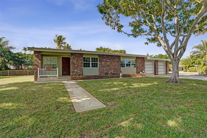Welcome to a home that truly feels loved. Set on an oversized 15,000 sq ft lot—rare for Wilton Manors—this charming 2/2 with a full 2-car garage offers room to breathe, grow, and create your future vision. Full impact windows bring peace of mind, while the interior tells a story of decades of care and pride. Huge extra space in garage. The home is exceptionally clean and well maintained, offering the perfect canvas for modern updates or a complete transformation. Step inside and feel the warmth immediately—this is the home that invites you in, wraps its arms around you, and reminds you why Wilton Manors living is so special.