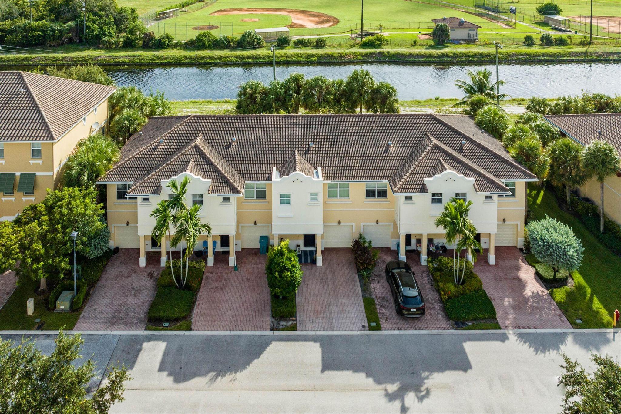 ''Vistabella'' Light, Bright & Spacious 2 Story, 3br, 2.5ba, 1Car Gar, Wide Driveway, Corner Townhome, Former Model, Tranquil Canal Views, Freshly Painted, New AC, Tile Floors Down, Plush Carpet Upstairs, Upgraded Crown Molding & Baseboards, Kitchen: 42'' Solid Wood Cabinetry, Granite Counters & Backsplash, SS Appliances, New Dishwasher and Microwave. Front-loading Samsung Washer / Dryer, LED Recessed Lighting, Large windows, Paver Patio, Huge Primary Bedroom w Tray Ceiling & Spacious Closets. Pre Wired Home Speaker System, Prewired for Security Cameras, Resort Style Pool and Scenic Walking Paths. Amazing Landlord! LOCATION, LOCATION, LOCATION! Mins to Beach I-95, Tnpk, Golf, Walk to Shops, Restaurants, Nightlife & Entertainment! True South Florida ''Lifestyle Living'' at Its Best!