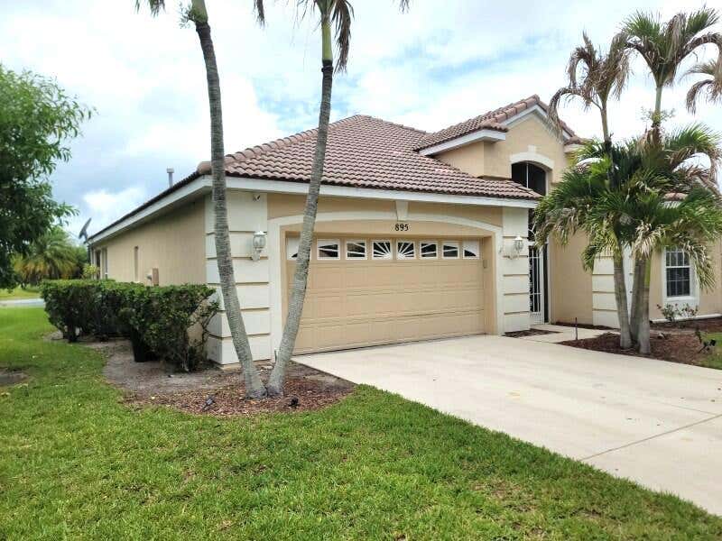 Photo of 895 SW Lake Charles Circle, Port Saint Lucie, FL 34986 (MLS # B26043800)