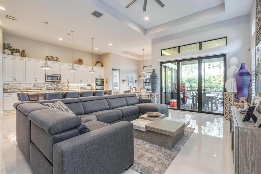 Luxury 55+ living at its finest in Four Seasons at Parkland- now attractively offered at $899,000. The sought-after Cerelia model offers 2 bedrooms plus an office/den, 2.5 bathrooms, and a 3-car garage. Enjoy Florida living with a beautifully designed custom inground pool featuring fountains and an outdoor shower, perfect for relaxing or entertaining. The screened lanai with waterproof plank flooring adds extra living space. Upgrades include, a whole-house generator, impact windows, and an air-conditioned garage. Inside, 24'' porcelain tile, tray ceilings, custom walls, and window treatments shine. The gourmet kitchen features a gas stove. Community amenities include a grand clubhouse, two pools, and more. A must-see home * 3-car garage that can be converted to a 2-car garage allowing to add an additional room