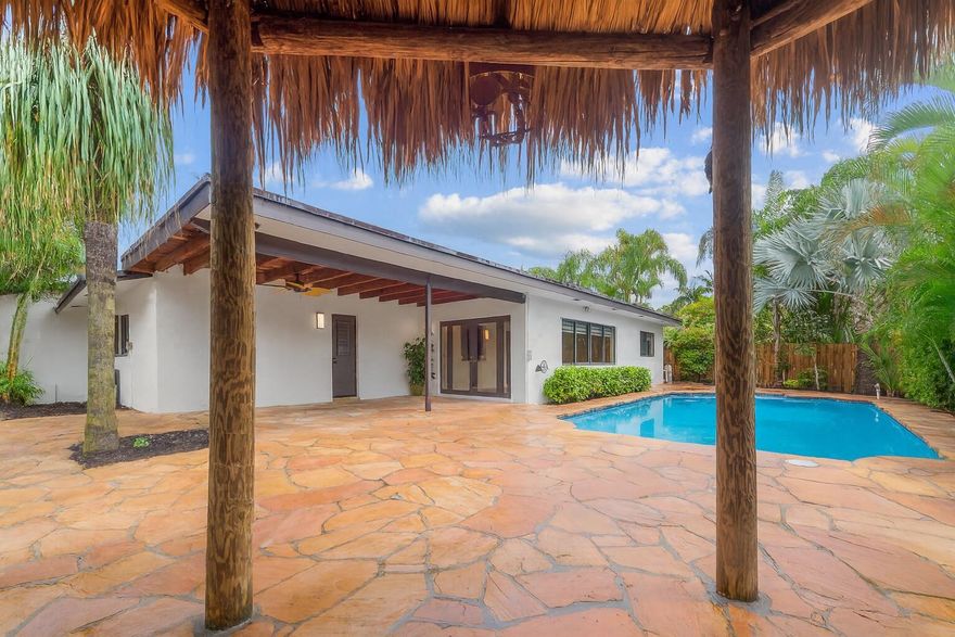 Updated 3BD/2BA pool home in highly desirable Pembroke Lakes NO HOA! Features a remodeled kitchen with large island, gas stove with pot filler, ducted range hood and built-in bar with dual wine coolers. Perfect for entertaining. Natural gas services stove, water heater and dryer. Open layout with wood-burning fireplace, impact windows, built-in closets, new window treatments, a (2016) AC and (2021) gas water heater. Enjoy the resurfaced pool, custom rock-paved patio, tiki hut with electric and mango tree. 2-car garage with in-wall AC, cabinets and  sink. Close to shopping, dining, A rated schools, parks and highways!