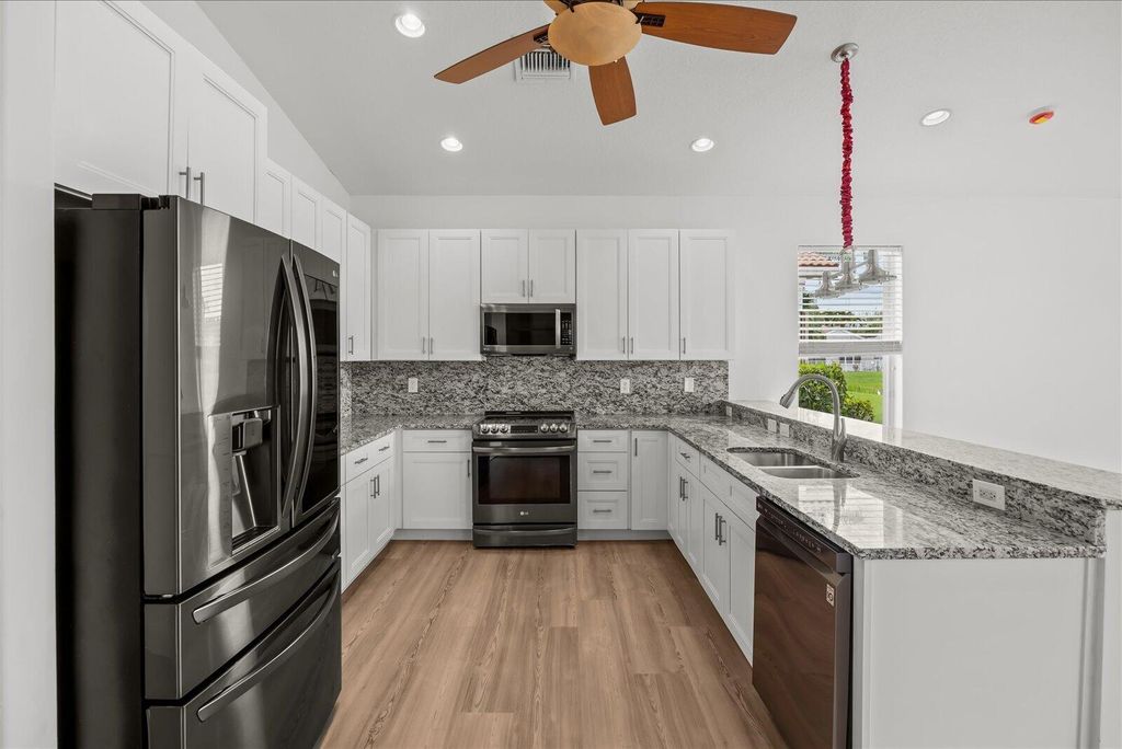 Photo of 7558 Tarpon Cove Circle, Greenacres, FL 33467 (MLS # B26005089)