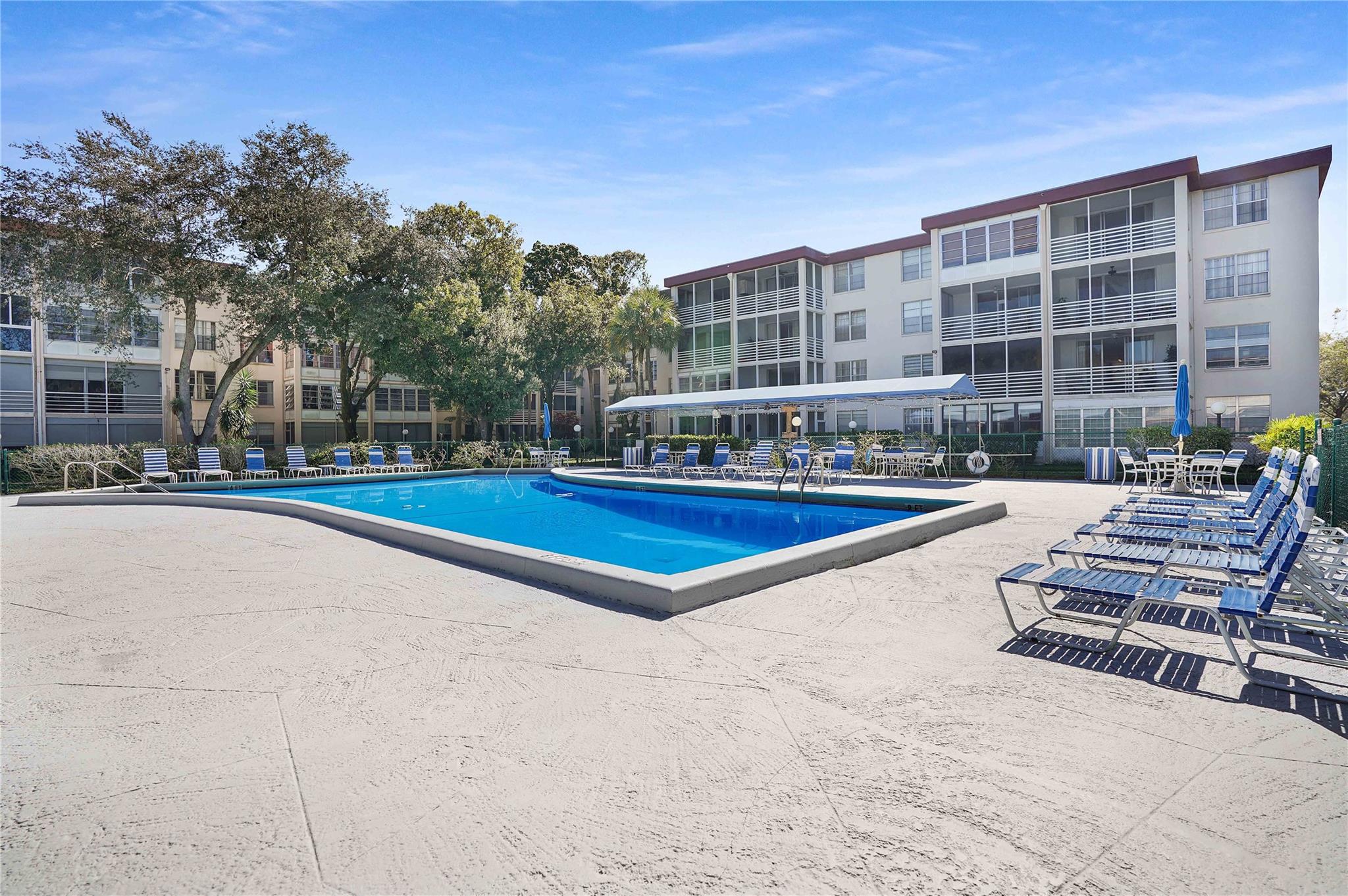 Discover this well-kept 1-bedroom, 1-bathroom condo, offering a peaceful retreat in a welcoming 55+ gated community. Conveniently located near Florida Medical Center and Oakland Medical Mall, with easy access to public transportation right across the street. Step inside to find a spacious enclosed balcony overlooking lush gardens, currently used as a versatile guest space. Recent updates include newer central air conditioner (2022). Residents enjoy access to an elevator, laundry facilities, a sparkling swimming pool, and a community room with pool tables, fostering a lively and engaging environment. Seasonal rentals welcomed after first year of ownership.