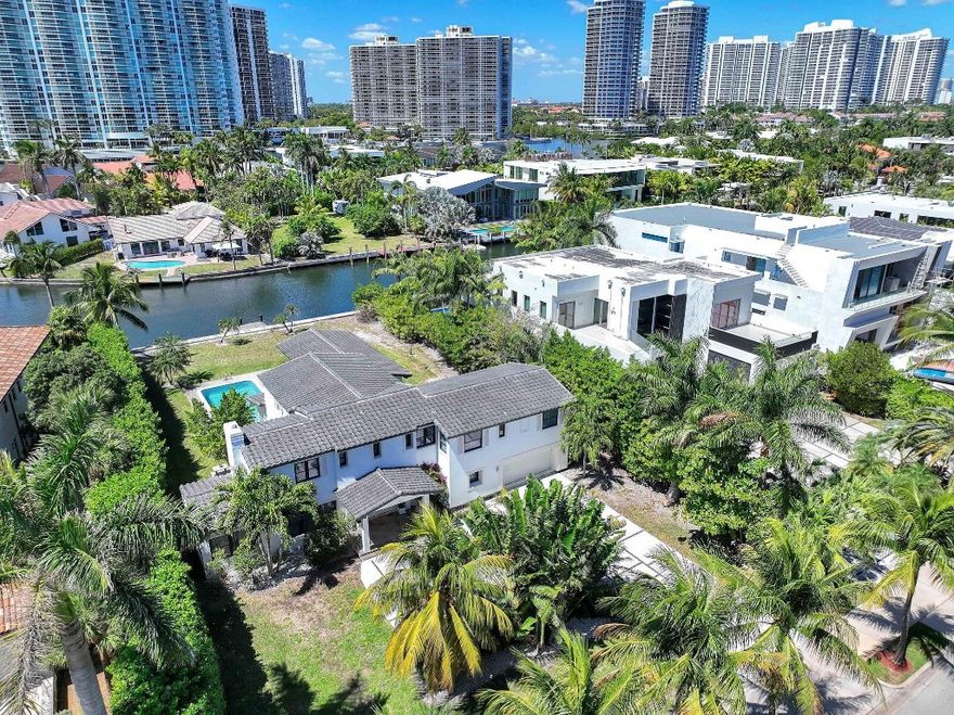 Beautiful desired Golden Beach updated home on the water. Two-story spacious home features, a guest house, heated pool & 100-foot sea wall on the intercoastal for a large yacht. Well-kept home has a large kitchen with breakfast counter, stainless steel appliances, gas stove, kitchen island & new cabinetry. Huge living area with French doors to backyard, pool & covered outdoor dining area with gas grill, great for entertaining large parties. Ample room by pool area for sunbathing. Formal dining & living areas, playroom & all updated bathrooms. Upstairs bedrooms have wood floors, downstairs has elegant white tile throughout. Large driveway for 8-10 cars. Town of Golden Beach offers a clubhouse, private beach, tennis, pickable, basketball & their own police department. Town building spa/gym