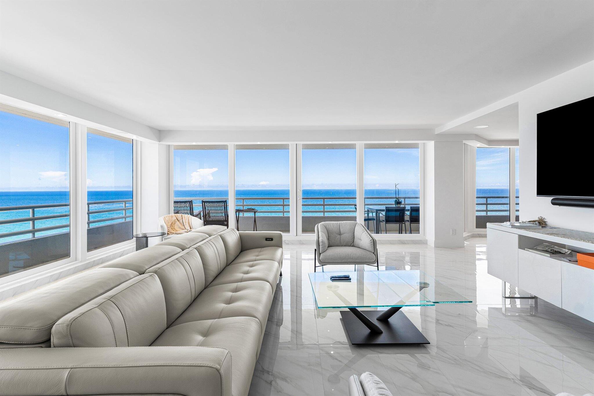 Completely and artfully reimagined, this spectacular 3-bed 3.5-bath + den wraparound corner residence offers 3,117 square feet of oceanfront luxury in Boca Raton's most prestigious address, The Addison.Perched on the 15th floor, this designer-curated unit showcases panoramic Atlantic views to the east and sweeping city vistas to the west. A grand foyer opens to an expansive living area with a built-in bar and seamless flow to the wraparound balcony, finished in matte marble-look porcelain tile -- an extension of the high-gloss porcelain flooring that flows consistently throughout the home. All bathrooms feature clean white porcelain tile for a refined, spa-like feel. Every detail has been meticulously upgraded: new doors, pipes, a full water filtration system,electric shades throughou