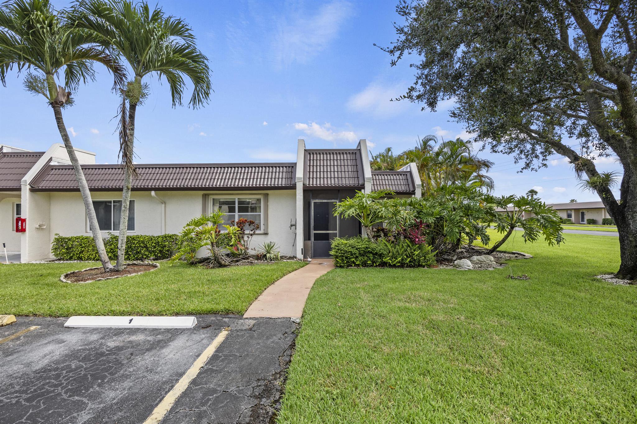 Welcome to the largest waterfront villa available in the desirable newer section of Golden Lakes! This spacious and light-filled 2 bedroom, 2 bathroom home offers comfort, style, and serene water views--all in a peaceful 55+ community in the heart of West Palm Beach.Step inside to find an open and welcoming floor plan, thoughtfully designed for easy living and entertaining. The oversized, fully enclosed patio is under air, providing the perfect flexible space for a cozy den, hobby room, or simply relaxing while enjoying tranquil lake views year-round.Both bedrooms are generously sized, with ample closet space and natural light. The primary suite features its own private bathroom for added convenience and comfort. The second bedroom is perfect for guests or can serve as a home