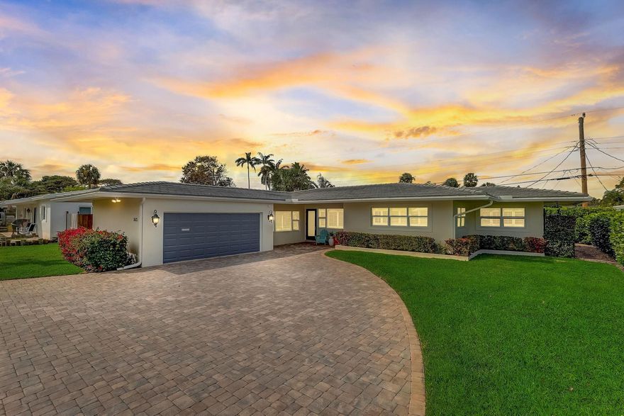Immaculate single-story poured concrete home exudes safety and solidity. A sprawling paver driveway and meticulously landscaped surroundings set the stage for this 2-bed, 2-bath + den abode. Complete impact windows and doors,  ensure peace of mind. New flat tile roof in 2022! Hurricane-rated garage. True 2CG. Updated PVC plumbing & electric add to the home's appeal. The custom chef's kitchen boasts a natural gas cooktop, S.S appliances w/double oven & expansive island for entertaining. The wine bar & den Murphy bed is set up for added guests & versatility. The primary bath has been newly renovated with custom shelving, a double vanity, & a shower seat. Enjoy a lifestyle of leisure & convenience with proximity to the beach, golf course, amphitheater, and dining along Atlantic BLVD.