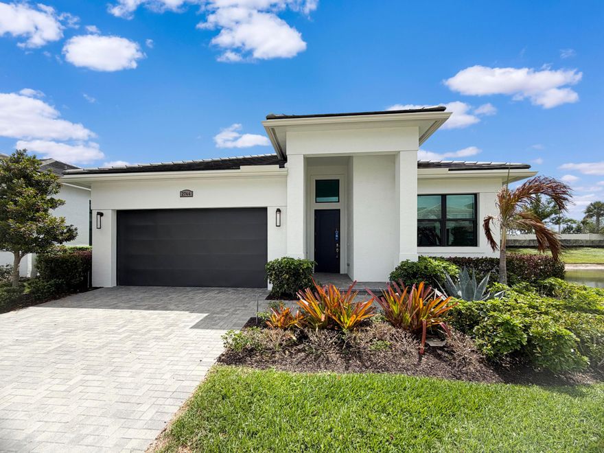 Introducing 2744 SE Ashfield Dr, a residence arranged for everyday practicality, featuring a kitchen with an accent backsplash and all stainless steel appliances. The kitchen includes a functional island, complementing the primary bathroom's layout with double sinks. An exterior covered patio provides a dedicated space for outdoor use. This property presents a well-appointed design focused on daily living. Included 100-Day Home Warranty with buyer activation