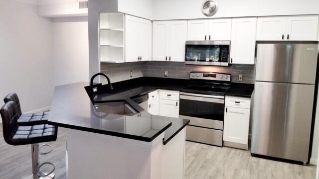 Beautiful updated 2nd floor apartment in Mezzano; all ages welcome. Open concept one bed, one bath lives large, with high ceilings and clean modern finishes. White cabinets and sleek black granite countertops. Separate dining area or office off the kitchen which includes breakfast bar. Large bedroom with walk in closet. Full size black stainless Washer Dryer, luxury vinyl flooring in living areas, dark slate tile in bath. Impact glass to keep it safe clean and quiet. Breezy balcony for a breath of fresh air in this quiet contemporary community. Luxurious amenities include massive pool, fitness center, sand volleyball court, playground, clubhouse and cafe. Close to everything with quick access to the freeway. It's time to leave the stress, decompress, and LOVE WHERE YOU LIVE!