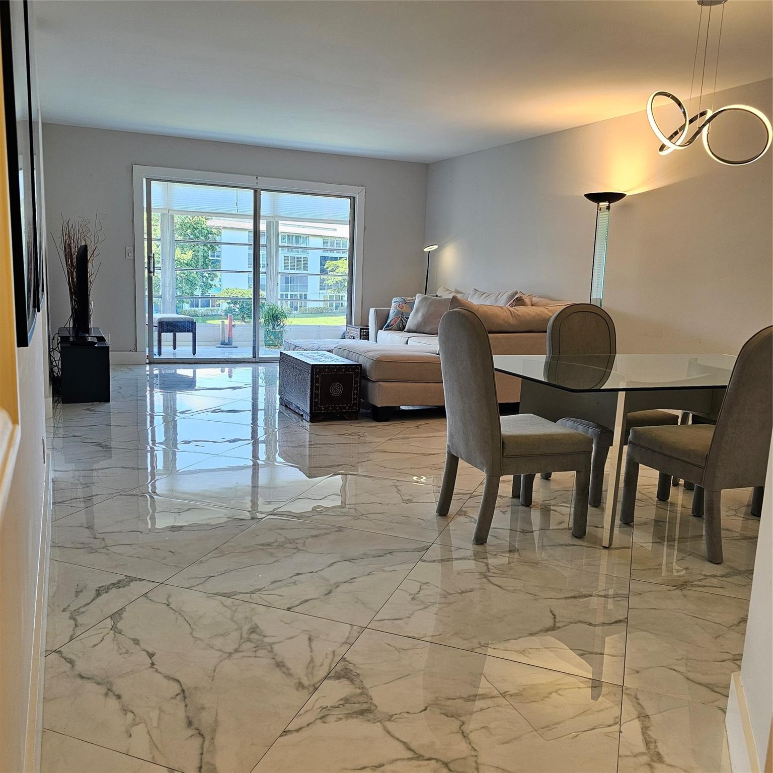 Updated 2-Bedroom 2 Bath Condo with Water Views. Discover a vibrant, amenity-rich lifestyle in this beautifully condo located in the active 55+ community of Wynmoor in Coconut Creek, Florida. This second-floor unit has been tastefully modernized for comfort and style. Beautiful tile flooring throughout provides a clean and cohesive look, complemented by elegant plantation shutters. Newer Air conditioning and hot water heater. The spacious and bright layout includes a cozy eat-in kitchen as well as a separate dining area, perfect for meals and entertaining. For ultimate convenience, a washer and dryer are located right in the unit. Step out onto your enclosed patio and enjoy serene water views—your private oasis for a morning coffee or an evening cocktail.