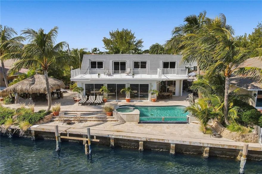 BEAUTIFUL DIRECT EAST FACING INTRACOASTAL HOME NEAR THE HILLSORO INLET *IN A NO WAKE ZONE!* THIS RARE FRENCH PROVINCIAL ESTATE OFFERS A TOP OF THE LINE CHEF'S KITCHEN WITH VIKING AND SUB-ZERO APPLIANCES, FULL WET BAR, TIKI HUT, INFINITY POOL, & SPA. NO FIXED BRIDGES! 82' OF WATERFRONT! NEW DOCK PERMIT AND PLANS FOR A 40' DOCK AND BOAT LIFT HAVE ALREADY BEEN APPROVED WITH US ARMY CORP OF ENGINEERS!