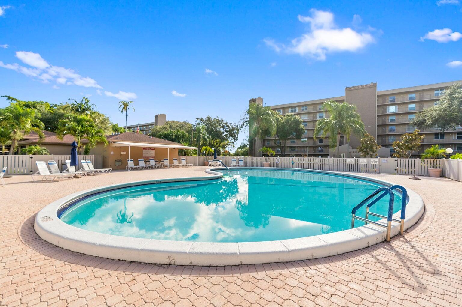 Prime Location! Spacious 2-Bed, 2-Bath Condo with Eat-In Kitchen. This unit offers in-unit washer and dryer, plenty of closet space, and stunning views from both the front and patio. Enjoy a variety of amenities including a large heated pool, clubhouse with a library, exercise room, pool table, meeting room with stage, and outdoor BBQ area. The community is open to all ages & conveniently located near shopping, restaurants, and with easy access to the beach, I-95, Turnpike, Sawgrass Expressway, and top-rated schools. A must-see!