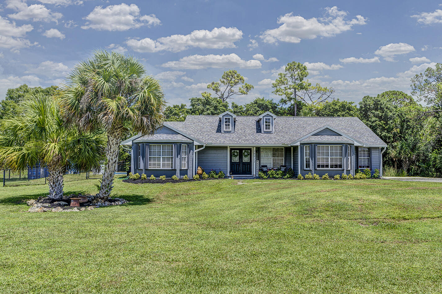 Welcome to this beautifully maintained 3 bedroom, plus bonus room, 2 bathroom home in Loxahatchee with NO HOA! Situated on 1.47 acres, this property offers privacy, space, and freedom. Enjoy your own private pool in a fully fenced in yard, perfect for relaxing or entertaining. The home features a 1 car garage, new roof (2023), AC (2021), and water heater (2022) for added peace of mind. This home also offers plenty of space for parking boats, RVs, or trailers. Located on a paved road and just minutes from schools, shopping, dining, and the growing City of Westlake. Don't miss this rare opportunity for comfortable, private living in a great location!