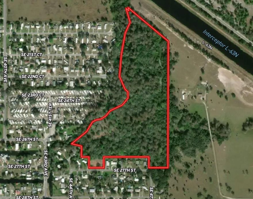 Located in the southeast section of Okeechobee within Brindaban Forest, this rare 34-acre offering consists of three parcels, including one heavily wooded tract and two additional buildable lots. The property features a peaceful creek, mature oaks, and towering cypress, creating a beautiful Old Florida setting filled with privacy and natural charm. Situated right in town yet surrounded by nature, this unique property is ideal for a private estate or custom homes, but is not suited for RV parks or dense development.