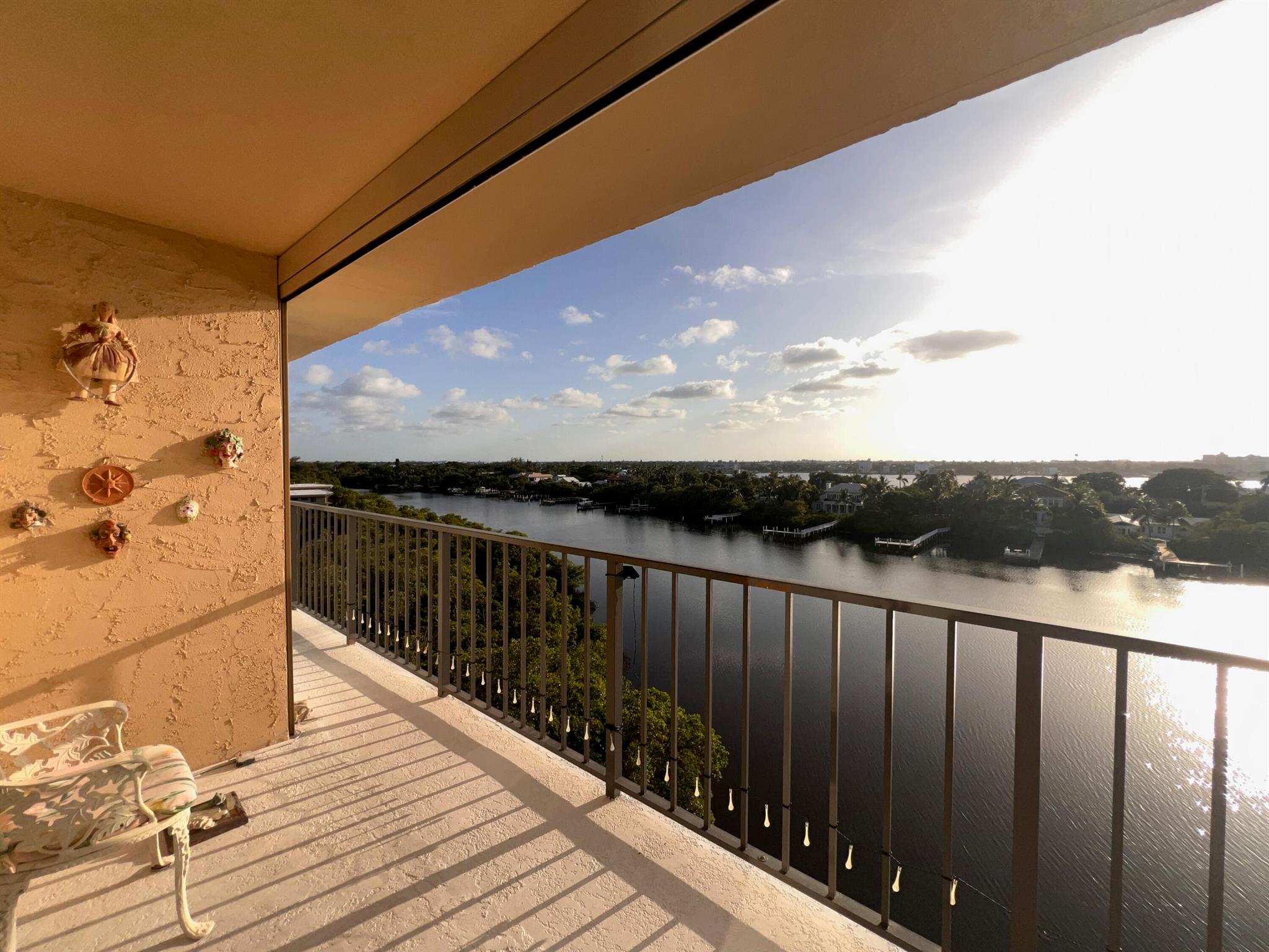 Experience the charm and prestige of Palm Beach living with stunning Intracoastal Waterway views. Located in the coveted 33480 zip code, this residence offers unobstructed Florida sunsets and deeded beach access. Watch sailboats glide by from your wrap-around balcony, or toast the sunset in peace.Inside, impact windows throughout provide serenity. The layout features a foyer entry, split bedrooms, and a kitchen with a sitting bar, pullouts, lazy Susans, and pantry storage. The master suite offers balcony access, a walk-in closet, and a bath with granite counters, a bidet, and linen closet.With an interior washer/dryer, two hall closets, and exterior storage, this home provides luxury and convenience. Schedule your showing today!
