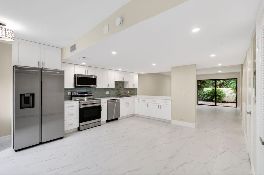 Rarely available in this sought-after Boca Raton community—and now's your chance! This newly renovated two-story townhome shows like a model. The light-filled kitchen stuns with waterfall quartz counters, white shaker cabinetry, and stainless appliances, flowing into an open living space framed by gorgeous tile (no carpet anywhere). Both en-suite bedrooms sit upstairs: the primary boasts a double-sink vanity, smart mirror, and private balcony; the second offers a built-in window seat. Every shower pairs a rainfall head with a handheld, and all 3 baths feature bidet toilets. Smart touches abound—Ring doorbell, keyless entry, upstairs stackable W/D, and abundant closets including under-stair storage. AC '26, water heater '25. Near Town Center, Whole Foods, Baptist Health & FAU!