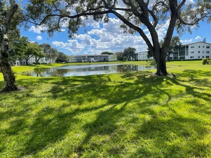 Corner first floor unit with majestic lake and garden vistas,   Fanshaw boasts no wait time to rent if so desired, will also allow LLC's.  Relax and enjoy a book  on the enclosed porch over looking the lake, patio has roll down shutters. 2 beds, 1 1/2  bath, corner unit is  original, well maintained. Newer carpet. Corner unit is light and bright. Primary bedroom has wall of closets, bathroom with shower,  Guest bedroom/den with walk in closet is ideal for family/guests/TV room. Guest half bath. Living areas carpet, dining and kitchen tile.  Century Village 's lifestyle is hard to beat,. Amenities includes: Theater, Community Pools, Indoor Pool, Courtesy Buses, Tennis, Pickleball, etc.  Close to major roadways, restaurants, shopping, 20 minutes to the beaches.  55+communiy.