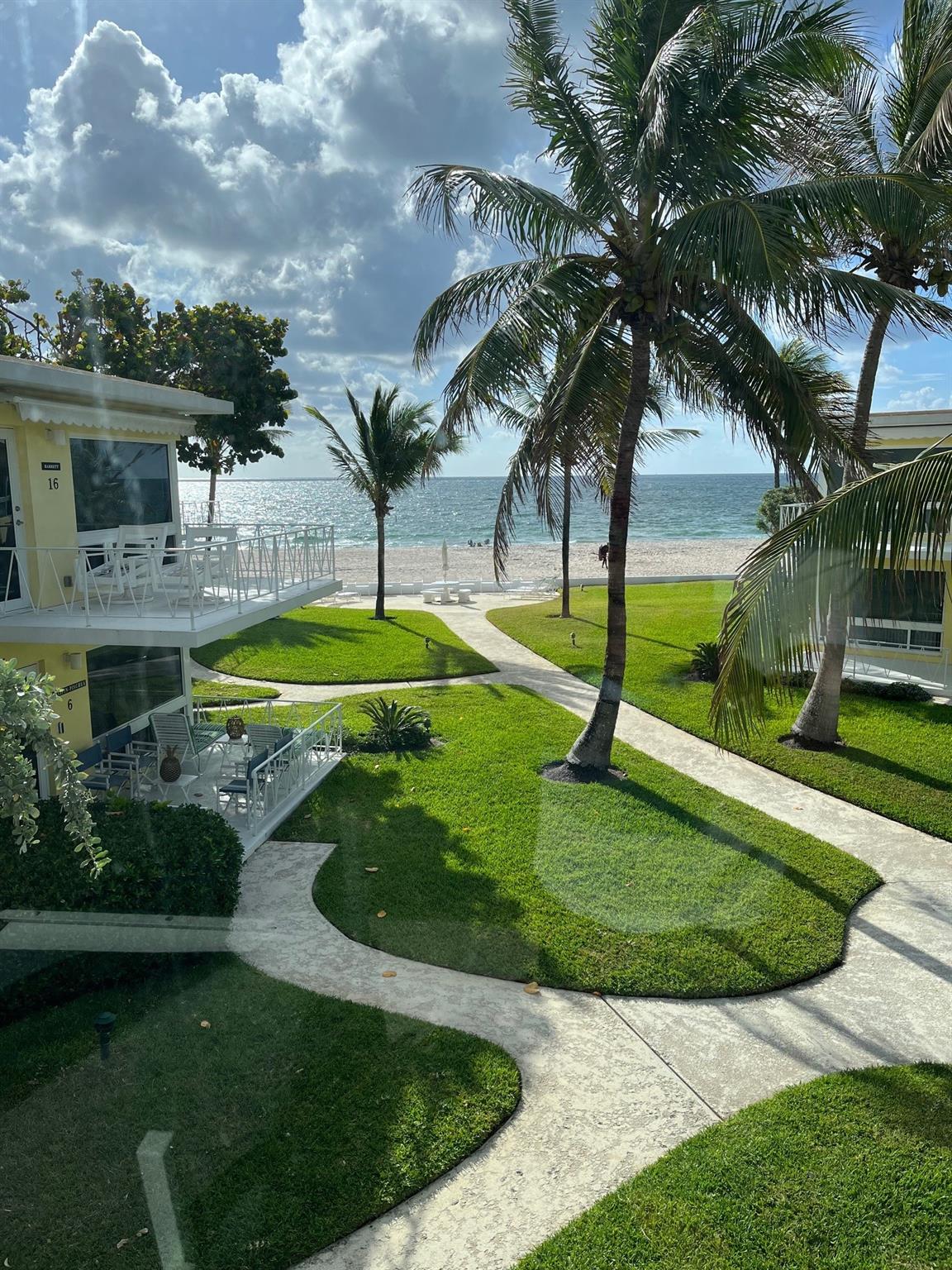 True Old Florida Charm with Mid-Century Character, nestled Ocean Front with Magnificent Ocean Views! This 2 bdrm/2bath Gated Co-Op, in Lauderdale By The Sea, has only 14 units. Boasting 1280 sq ft, with an open living, dining and kitchen area, has floor to ceiling windows, doors, and two large open balconies that face east and west. Tiled floors, newer roofs, concrete restoration, and impact windows and doors in 2019. New central sanitary sewer system to municipal sewer line and brick paver driveway in 2025. Covered Parking, Heated Pool in the sun and Swaying Palm Trees all on one of the Nicest Beaches in the County! Minutes to Lauderdale By The Sea and Pompano, boasting shops and eateries, and piers. Here IS your Beautiful Casual Florida Lifestyle. Onsite Property Management, too.