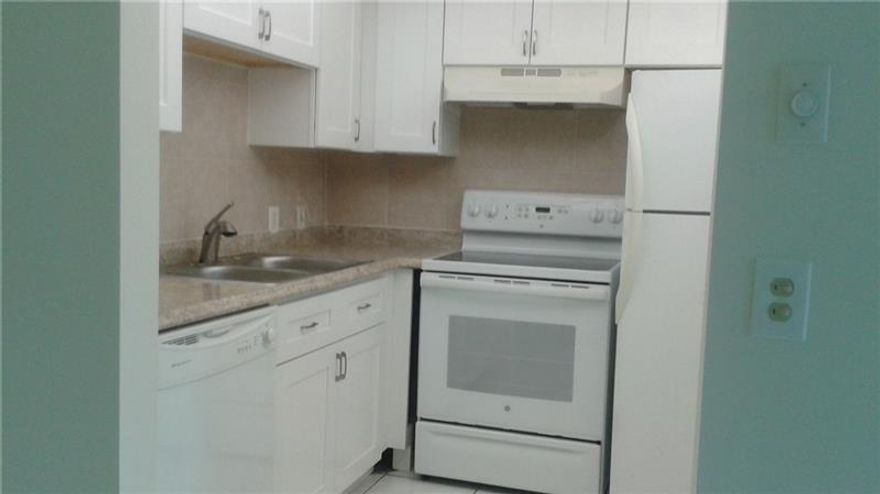 Investors ! Tenants in place ! Prefers to renew.  Rent is $950/month. Improved kitchen. Improved baths.Convenient  ground floor unit. Easy entry. Assigned parking not far from entry. Screen porch with roll down shutters.  This condo has extra storage walk-in closet. CENTRAL air conditioning ! All tile -- no carpets ! Walking distance to pool and association bus stop. Located in nice quiet corner of the gated complex.