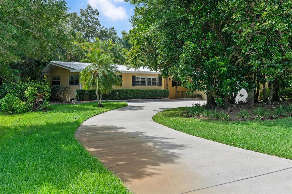 This beautiful home is in the Royal Park neighborhood of Vero Beach, located within 2 miles of the beach and an easy walk to Miracle Mile. It is a 3/2/2 with an inground pool lined with palm trees and flowers for your private oasis. This is a unique, shady, large lot with a fully fenced in backyard. As you drive this tree lined street and arrive, you will see the long A1/2 circle driveway and beautiful landscaping. A section of the yard would be great for a dog run and plenty of shade. The metal roof is only 5 years old, city water & sewer, shutters, full gutters and 2 nice patios to enjoy your favorite drink. French doors lead you to the pool or out to a shaded patio. Custom tiled floors throughout. This house has been well kept, the A/C 2017, WH 2019. Come enjoy the Vero Beach Lifestyle!