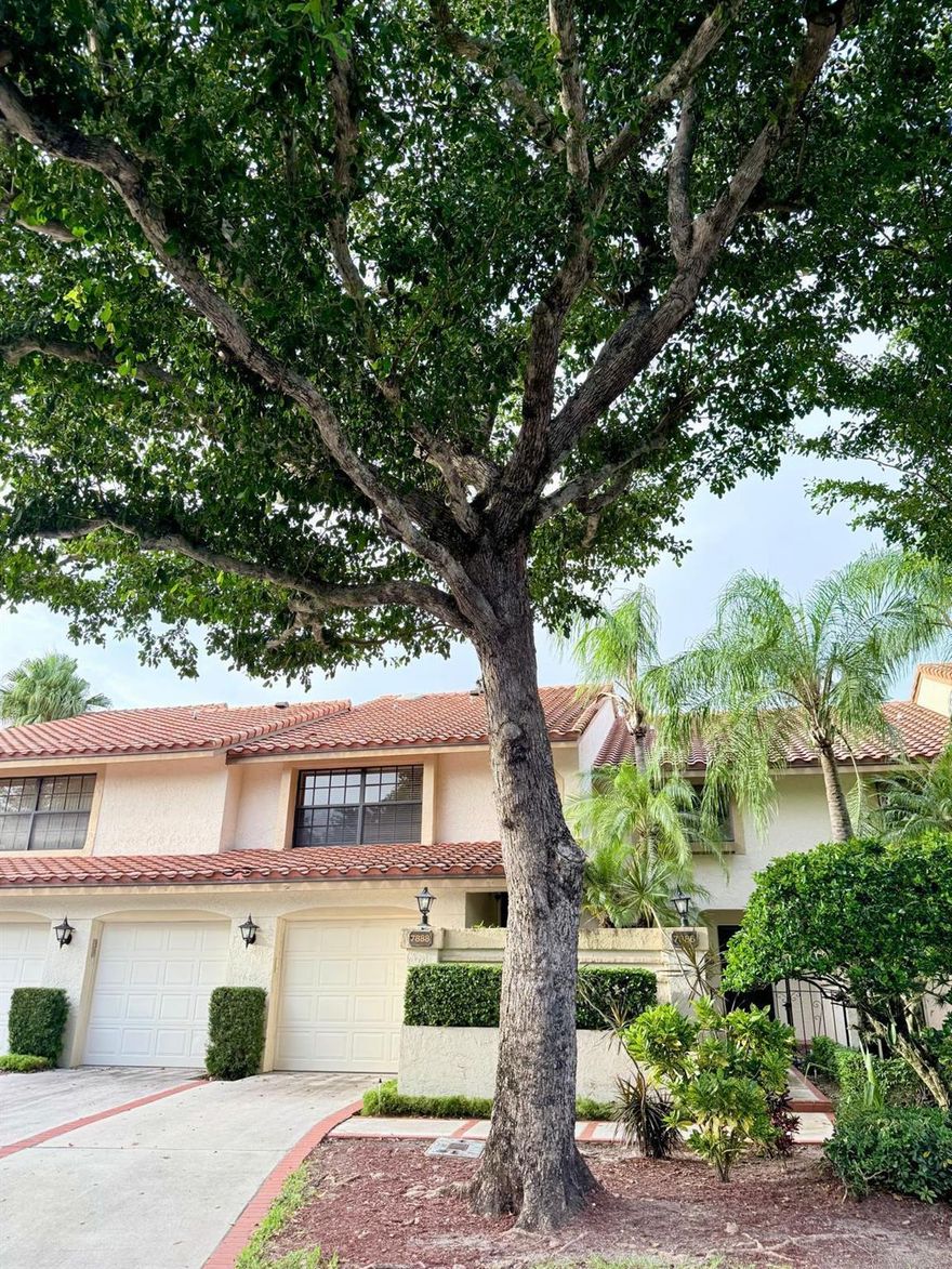 Nestled within the pristine gated community of Boca Pointe, this gorgeous 3-bedroom, 2-bath , 1-garage coach home is a true gem. This lovely home boasts its very own EV charger, vaulted ceilings in the living and dining areas, along with strategically placed skylights, that effortlessly infuse the space with natural light. Marble flooring in the main areas adds a touch of elegance, while the well-crafted kitchen features solid wood cabinetry, granite countertops, and stainless steel appliances. The master suite is your private retreat, complete with a double sink vanity and a soothing Roman tub. The 2nd bathroom has been updated with quality cabinetry and granite countertops. Step onto the balcony, and you'll be treated to serene views of the golf course and a tranquil canal.