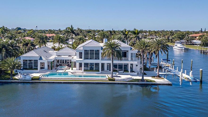 Enjoy the seclusion and tranquility of this contemporary Intracoastal estate located on a double lot with 285' of direct waterfront. This gated enclave on a private cul de sac  offers unparalleled eastern views of the Intracoastal over a resort style 65' infinity pool with a cascading marble spa. A canal side dock with two lifts, 50 ton ''Tide Slides'' and protected dockage for a 100+' yacht. Newly  renovated chef's kitchen, first floor master suite with his and her baths, plus three oversized walk-in closets. Other amenities include  a professional quality theater, a complete fitness center, and private office space. Less than 10 minutes to the Palm Beach International airport, renowned Worth Avenue and the fine dining, shopping, and entertainment Palm Beach has to offer. Truly an exceptional, rarely available tropical oasis for the discriminating buyer.