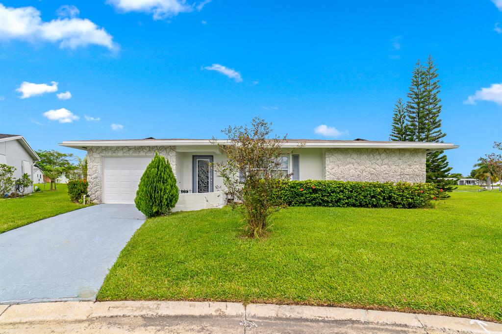 Welcome home to this immaculate 2 bedroom 2 bath home in the highly sought after 55+ community of Paradise Gardens in Margate. One of the largest lots in the neighborhood with panoramic, expansive water views. SOLAR PANELS make the home highly energy efficient and greatly reduce your expenses. The home offers essentially two primary suites with tons of closet space and large, partially updated bathrooms. The kitchen features granite countertops, and stainless steel appliances. The one car garage provides ample additional storage. The Huge screened porch is perfect for entertaining, relaxing and enjoying the unbelievable water views. Roll down/accordion shutters, newer laminate flooring and ample parking room round out the highlights. Association maintenance includes lawn care