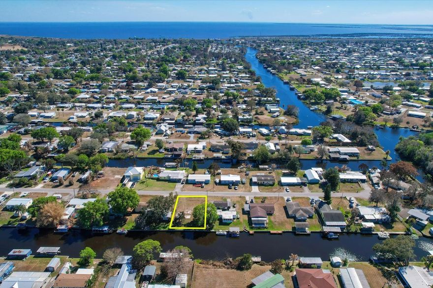 Exceptional canal-front lot on a quiet paved dead-end cul-de-sac on SE 21st Ct featuring approximately 76 ft of premium poured concrete seawall and 111 ft of depth. Located on one of the widest and deeper canals, with 42–48 inches of water depth at the seawall and deeper water outward, providing excellent boating access. Enjoy direct navigation to Taylor Creek and the Lake Okeechobee Lock for premier fishing and waterway travel. The lot is cleared and ready with hookups for a manufactured, mobile, or tiny home — ideal for immediate use or future investment.