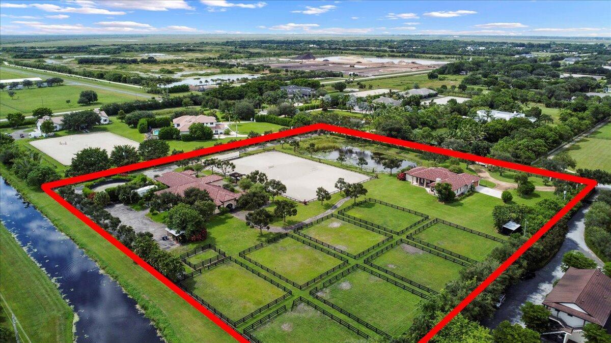 Amazing opportunity to be on the canal side of Sunnyland, TRUE hacking distance to WEF. 12 stalls (all w/rubber mats) available in this 16 stall barn-Landlord will keep 4, and will maintain the ring daily. This stunning barn was built in 2012, and the ring has since been widened, w/the footing upgraded to Martin Collins (fiber/sand mix). This barn spares nothing - air conditioned tack room, feed room, hay/shavings storage, laundry, studio apartment, powder room - and just wait until your horses see the paddocks! The custom 4 BD/4BA home is just a short walk from the barn, yet still maintains privacy with its own gate, circular driveway, and 2 car garage. Chef's kitchen, covered patio for a sunset view, split floor plan, perfect for those that need to stay close to the horses