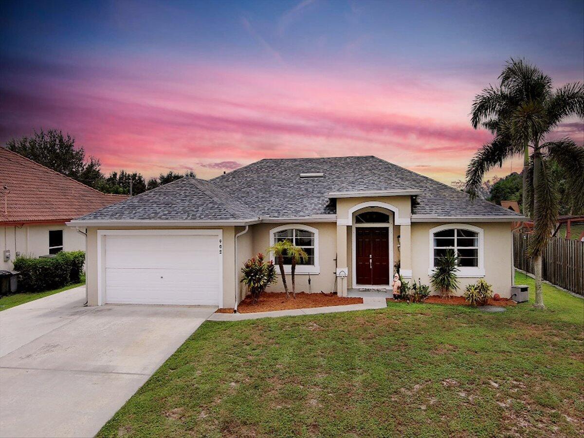 Immaculate 3-bed/2-bath CBS pool home on the canal in desirable Port St. Lucie! This beauty boasts a 2-car garage plus a extended driveway/pad perfect for parking your RV or boat. Step through the double-door entry with tile and laminate flooring throughout. Sparking stylish white kitchen with newer stainless steel appliance and granite countertops with plenty of storage. The split bedroom floor plan offers privacy, while the formal living and dining rooms are ideal for entertaining. Relax in your sparkling pool or hot tub, and enjoy peace of mind with sliding impact glass doors. Location, location, location this home truly has it all! Roof 2023/ AC 2024/Pool Heater 2023/Pool Pump 2025