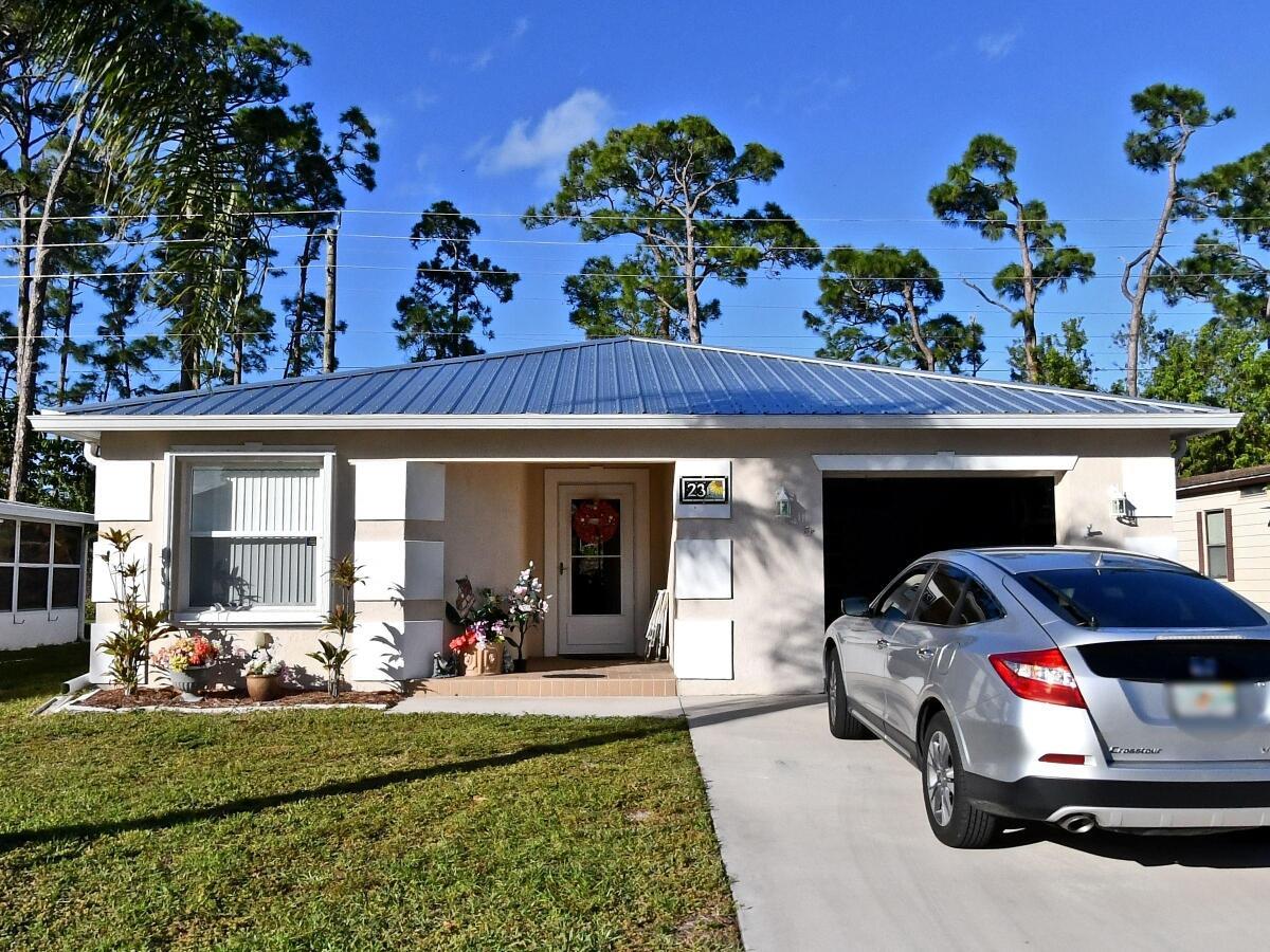 What a great deal, and a fabulous home! What an adorable home at a great price, comes with accordion hurricane shutters, and a metal roof WITH a transferable warranty that was just installed in 2022! Concrete block home ready for its next owner, backs up to a very private lot with no one in the rear, monthly fees are $832.55 and that includes a private golf course, 2 pools, gym, tennis, shuffleboard, pickleball, billiards, there is an unbelievable number of amenities all included. Sold unfurnished, the house is wired for a complete home generator (generator will not stay,) wood laminate flooring thru the main area and the bedrooms. Laundry room is just off the kitchen, master bedroom is a good size and there is a huge walk-in closet. The rear porch is 10x 20 it is another room in itself,