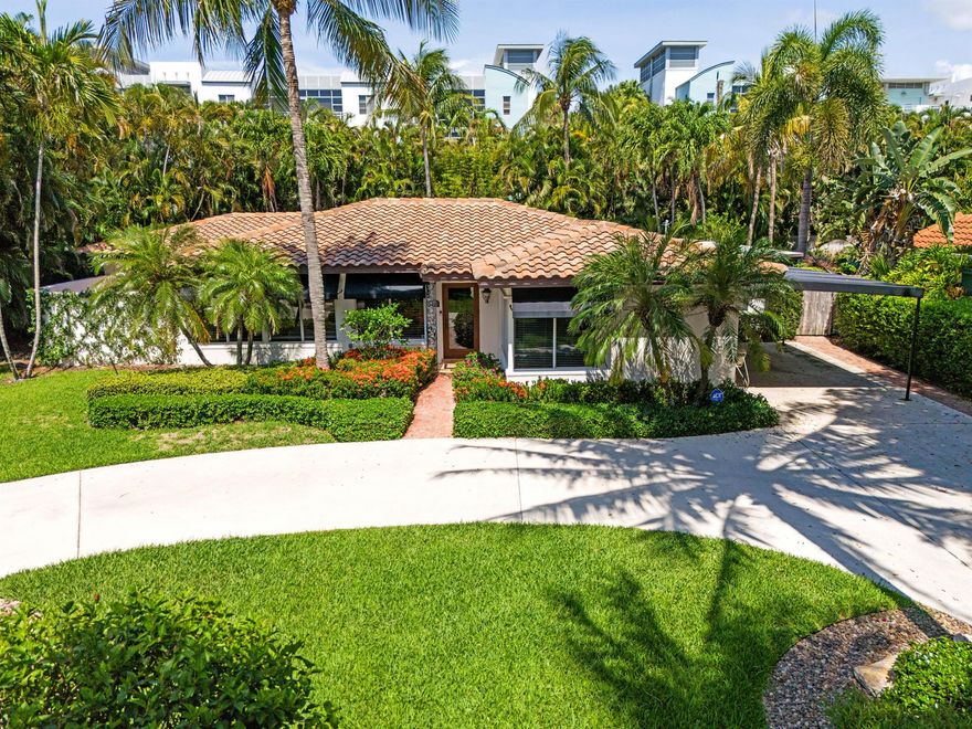 Discover the allure of 330 Southeast 7th Avenue, nestled on a charming street amongst beautifully renovated vintage cottages in Downtown Delray Beach and steps away from the Intracoastal. This residence offers the perfect combination of modern living and classic charm, ideally located just a few blocks from the lively Atlantic Avenue.   Set on a lot spanning over a quarter of an acre, this home features a circular driveway, covered carport  and impressive curb appeal.  This charming home features 3 spacious bedrooms, plus bonus room and three elegantly designed bathrooms, all encompassed within 2,662 square feet of refined