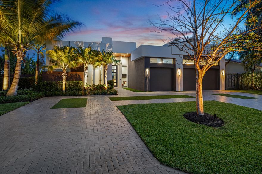 Chic, Modern Residence artfully crafted by award-winning Albanese Home Builders, sited on an oversized corner lot in sought-after Lighthouse Point. Light-filled interiors reveal 3 bedrooms, 3.1 baths, a private office & 2,805± SqFt of refined living. The chef's island kitchen showcases Thermador refrigerator, freezer, gas range & double wall ovens, complemented by a bar with dual wine coolers. Wide-plank oak floors grace the bedrooms while Italian porcelain flows throughout the main living areas. Additional highlights include a 3-bay garage, 24KW gas generator, tankless gas water heater, impact windows & doors, and Control4 home automation. Outdoor living is perfected with a resort-style heated pool & a large covered loggia with summer kitchen & roll-down screens.