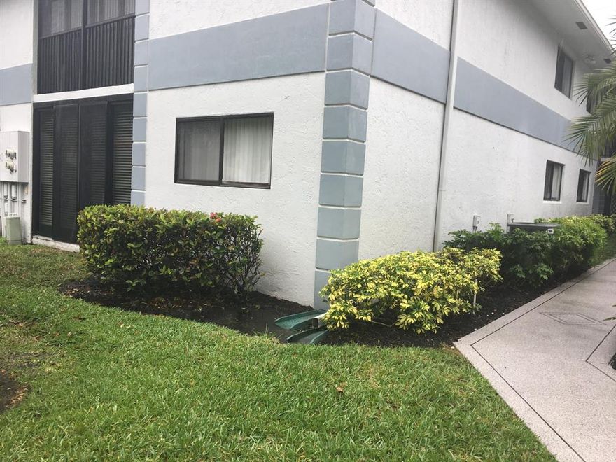 FIRST FLOOR END UNIT ~ Gated Community.  .  2 bedrooms 2 baths. 
Eat in Kitchen, Porch with impact windows/doors, Utility Room with Washer and Dryer and Storage.  Master bath / tub~shower. Master fan/light. Built-in mirrored Master closet. 
Ceiling fans in Master, 2nd Bedroom, Porch, Kitchen.  
Community Pool overlooking lake with Activities PLUS.
New roof has been approved for the building.