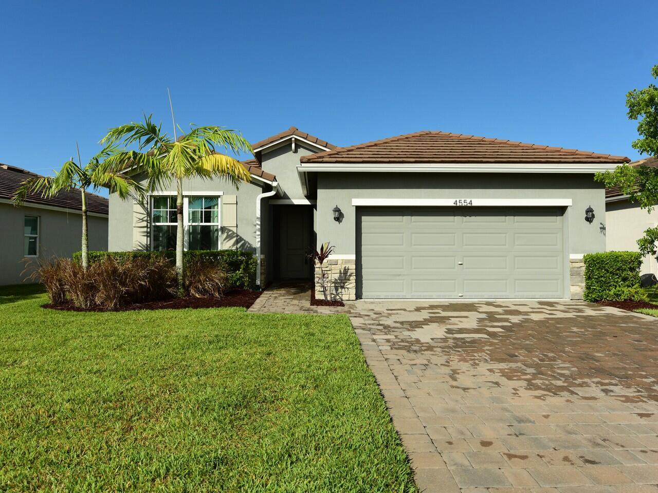 This like-new 3/2/2 home in Jensen Beach offers a perfect blend of modern living & prime location, just minutes from the beach. The split floor plan provides privacy, while impact windows & doors ensure safety & preserve the view. The spacious kitchen features a large island, quartz countertops, high-end appliances, pantry & decorative backsplash, flowing seamlessly into the great room. The ma suite includes big walkin closet & luxurious bath w/dual sinks & walk-in shower. Enjoy outdoor living w/pavered covered scr'd porch. Oversized 2-car garage w/pavered driveway. The home is equipped w/smart technology & security system. The gated community's amenities, include tennis courts, pools, golf course, rest & bar. This home is ideal for full time living or a coastal getaway! Martin Co Y