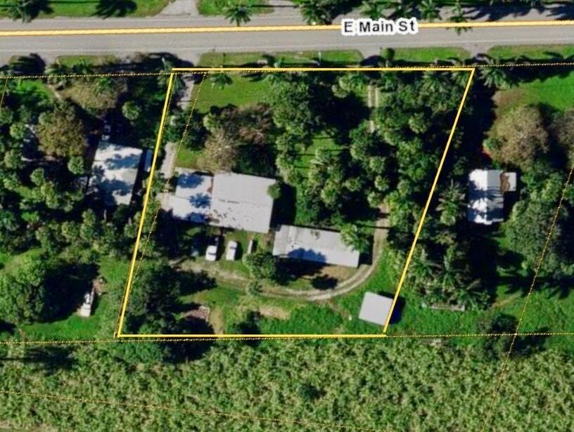 Spacious Acreage Home with Guest Suite & Private Elevator. Welcome to your dream home in Pahokee, Florida set on a full 1-acre lot minutes from the Lake Okeechobee boat ramp, offering premier boating, fishing, and outdoor recreation access.This solid CBS construction home features a 3-bedroom, 2-bath main residence plus a 1-bedroom, 1-bath attached guest suite, perfect for extended family living or lucrative rental income. A private elevator provides accessibility, and the oversized 3-car garage with a bonus room opens the door to home gym, workshop, or office potential.Enjoy the privacy of mature landscaping, fruit-bearing trees, circular driveway and RV/boat parking plenty of space for guests and toys with no HOA!! A true gem for nature lovers, investors, and vacation home!
