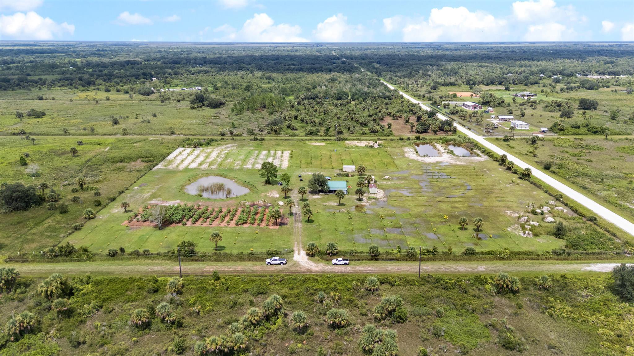 Discover this fully operational 10-acre agricultural property in Okeechobee, Florida - ideal for farming, investment, or a private retreat. This property is set up as a working agricultural operation and also provides the perfect foundation for a private retreat or income-producing investment. The land is fully fenced and features a complete underground irrigation system that services every tree on the property. Currently in production are a variety of tropical fruits including papaya, mango, sugar plum, banana, and coconut, offering both personal enjoyment and commercial potential. Adding to the uniqueness of this farm are three stocked fishponds, enhancing both the beauty and versatility of the land.