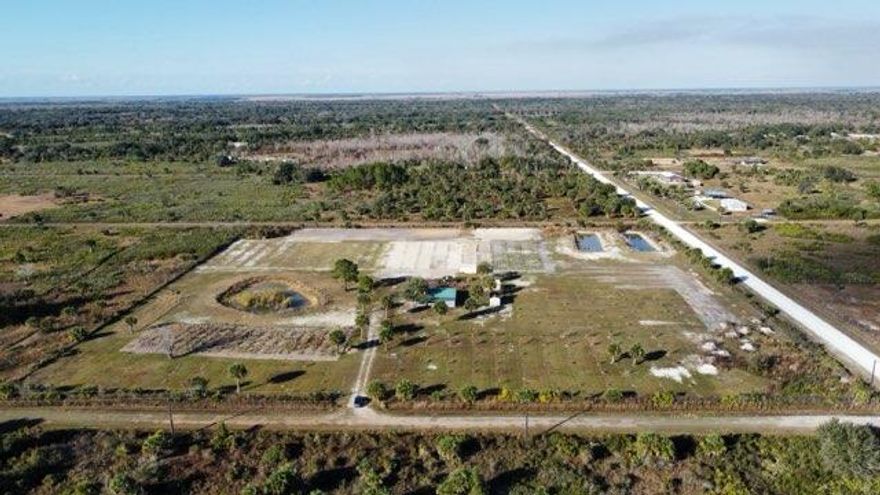 Fully operational 10-acre agricultural property in Okeechobee, Florida. This property is set up as an active agricultural operation and includes full perimeter fencing and an underground irrigation system that services all planted trees. Current fruit production includes papaya, mango, sugar plum, banana, and coconut. Additional features include three stocked fishponds, a large pole barn, two wells, separate bathroom facilities, and multiple outbuildings including a shed and office. A Kubota tractor and gas-powered golf cart are included in the sale. Internet service is available through Hews. This property offers established agricultural infrastructure suitable for continued farming, investment, or private use. A mobile home can be added for an additional fee; inquire for details. The property also includes a large pole barn, two wells for reliable water access, separate bathroom facilities, and multiple outbuildings including a shed and office, providing plenty of functional space for day-to-day operations. This offering is further enhanced by the inclusion of a Kubota tractor and gas-powered golf cart, making farm management and transportation convenient and efficient. The property also has internet service provided by Hews, allowing you to stay connected while working remotely in a peaceful rural environment. With its established infrastructure, producing fruit trees, and valuable agricultural enhancements, this farm is truly a turnkey opportunity for farmers, investors, or anyone seeking a productive agricultural property in Okeechobee. Don't miss your chance to own this exceptional 10-acre tropical farm, fully equipped and ready for the next owner to enjoy and expand.