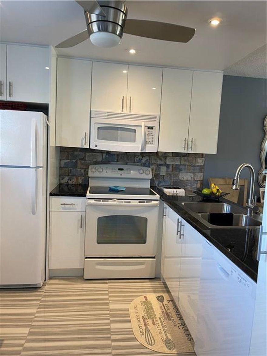 Gorgeous unit.  Fully updated including the kitchen and 2 baths.  The outside patio has been set up as guest room with A/C vent and privacy barn doors.  IMPACT WINDOWS.  TURN KEY.  come see it!!!  55+ no rent for 2 years.  secured elevator leading to second floor.  Easy and quick approval.  2 pools/movie theater/cable/water/many activities to join and enjoy. one car assigned parking only right in front of building
