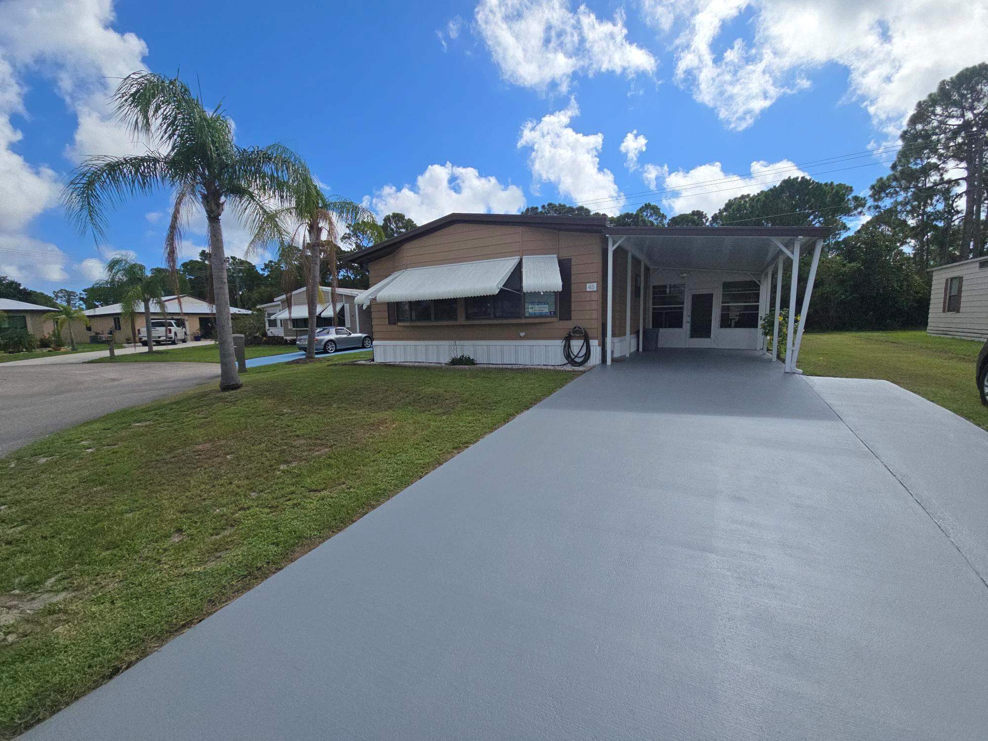 Beautifully Updated 2 Bedroom, 2 Bath Home - 1,416 Sq FtThis spacious, move-in ready home blends modern upgrades with timeless comfort. Featuring a durable metal roof and a light-filled windowed Florida room, it offers the perfect place to relax year-round. Inside, you'll find luxury vinyl laminate floors, fresh paint with elegant crown molding, and custom cabinets reaching to the ceiling topped with tiled countertops for a truly upscale feel. Additional highlights include marble window sills, custom doors with upgraded hardware, new toilets, and 36-inch vanities in both baths. The freshly painted driveway adds to the home's curb appeal, while ample storage and a workshop make it as functional as it is beautiful. Enjoy privacy on your perimeter lot backing to wooded views.