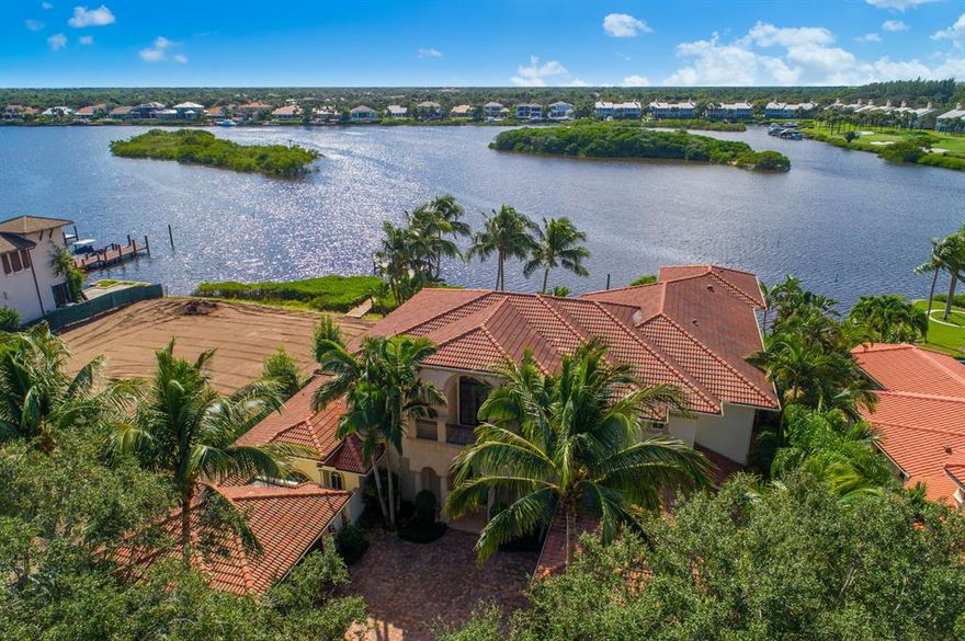 Magnificent 7,500 sf 5 bedroom, 6.5 bathroom waterfront estate in the premier location within Admirals Cove featuring the best and most panoramic water views with deep water dockage at the end of the cul-de-sac! Custom built by Mustapick in 2007 and updated in 2018, the home features a grand living room with ceiling to floor windows overlooking the expansive water views, spectacular chef's kitchen that flows into the family room and over-sized outdoor patio. The spacious downstairs master has a sitting area, 2 large walk-in closets, and a luxurious bathroom suite. The first floor also has the theater, office, powder room and an additional bedroom suite. The upstairs master suite has a grand balcony with panoramic water views, 2 other bedroom suites, an upstairs family room and game room... ... are also on the 2nd floor. The outdoor living area features a wonderful summer kitchen overlooking the heated pool and spa with water fall features. The dock can accommodate a 75' yacht, and has an additional boat lift. Nothing but the absolute finest finishes were used on this custom waterfront estate including all Anderson impact resistant doors and windows, beautiful ceiling detail with crown molding throughout the home, fine wood cabinetry, over-sized wine refrigerator, elevator and grand stairway, entire house generator, Viking and Sub-zero appliances and 4 car garage!