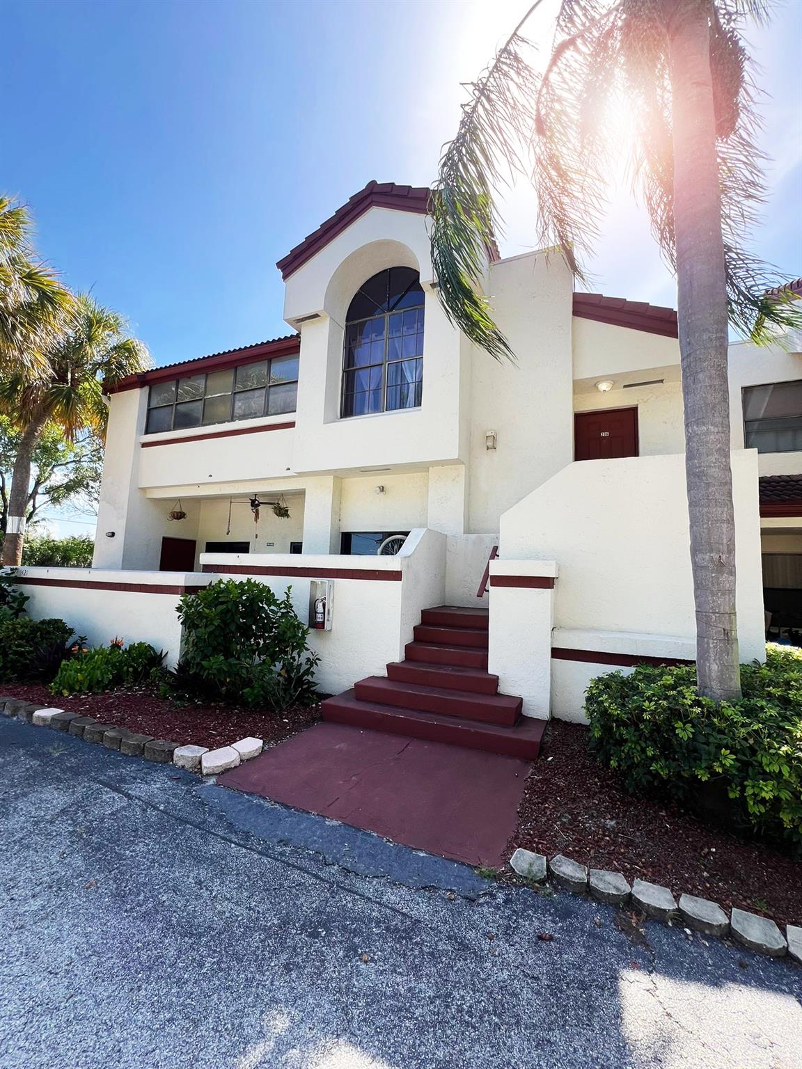 Beautifully updated 2/2 townhouse nestled in the heart of North Lauderdale. From the moment you step inside, you’ll be greeted by beautiful wood flooring that flows seamlessly throughout the living areas, complemented by tile in the kitchen. The vaulted ceilings enhance the open & airy feel of the home. The updated bathrooms add a touch of modern comfort. The spacious primary suite features its own private vanity area, perfect for morning routines! An enclosed patio space, offering a peaceful retreat from the Florida heat while still soaking in the sunshine & the second bedroom is move-in ready with a charming wood accent wall. The kitchen boasts rich wood cabinetry & ample storage, along with a convenient stackable washer and dryer. This home is effortless South Florida living.
