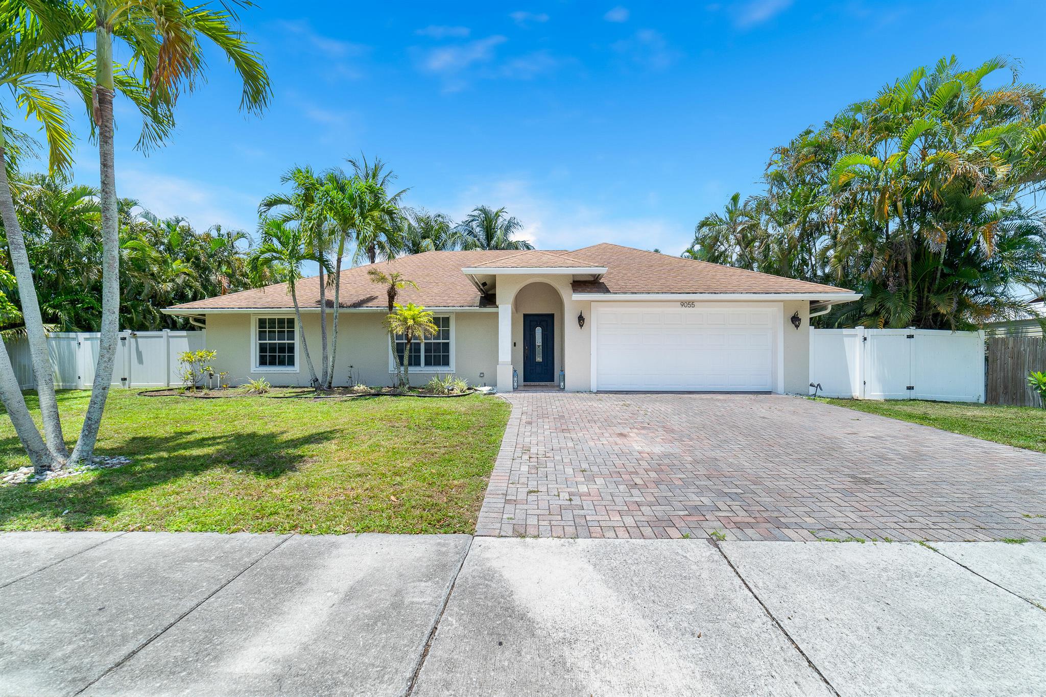 This spacious and well-maintained 4-bed, 2-bath home on a .23-acre lot in Lake Worth offers the ideal blend of comfort and opportunity. The open split floor plan features wood-look flooring throughout for a warm, inviting feel. A renovated kitchen boasts white ceiling-height cabinetry, stainless steel appliances, and a cozy breakfast area. The large screened and tiled lanai is perfect for relaxing or entertaining, overlooking a fenced backyard with paver patio for added privacy. With a 2-car garage and no HOA fees or restrictions, it's ideal as a primary residence or investment. Close to shopping, dining, top-rated schools, and Lake Worth's vibrant downtown and beaches.