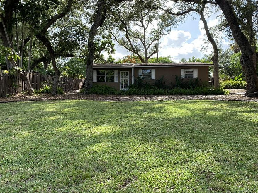 Rare park like setting, over 1/4 acre, entire property enclosed with 6' privacy fence. Walking distance to city park (two dog parks, lap pool, tennis, basketball). 3 bedrooms, full bath has Jacuzzi jet tub, 1/2 bath in owner's suite. Large room (425 sq ft) with its own AC, impact windows, can easily be converted to make the house 4-5 rooms (bedroom, office, workout rooms). Newer: roof, AC units, instant water heater, electric breaker panels inside and outside. Reverse osmosis water filtration system. Carport for two vehicles with adjacent fenced storage space. Tool shed, dog house. Trees in yard include oak, avocado, mango, mulberry, pomegranate, pineapple, aloe vera. Conveniently located near FLL airport, I-95, Turnpike, beaches, and shopping at Dania Pointe.