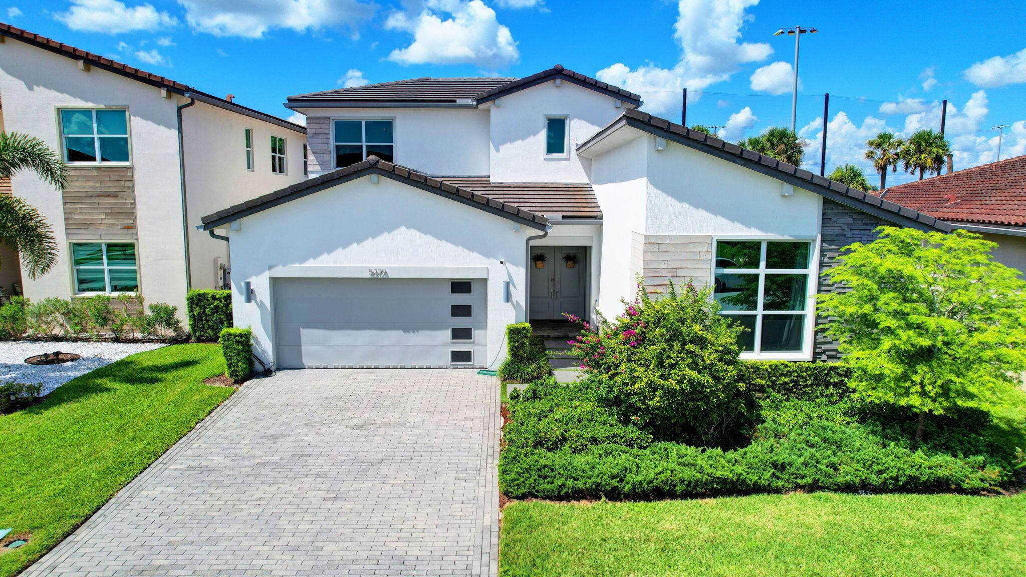 NEW CONSTRUCTION, NEW ROOF, IMPACT THROUGHOUT and an entire house GENERATOR and GAS STOVE plus huge lot for extended backyard. Where elegance meets modern living. This stunning newer construction home, conveniently located close to the turnpike and all the latest amenities, truly checks all the boxes. This exquisite residence has 24 x 24 porcelain tile throughout, perfect for today's lifestyle. The heart of the home is the open-concept kitchen, featuring a massive quartz island, cabinets (42'' soft close), 36'' gas cooktop, premium KitchenAid appliances, 2 Stoves, complemented by a generous pantry and . Designed for entertaining, the inviting floor plan seamlessly connects to the private outdoor space, walking distance....